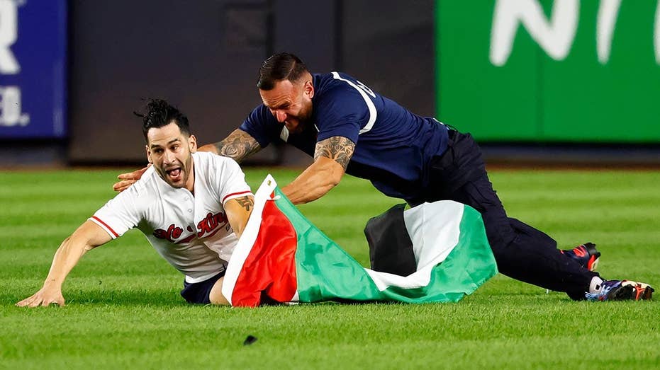 Yankee stadium security tackle field invader waving Palestinian flag during 9/11 anniversary game Yankee stadium security tackle field invader waving Palestinian flag during 9/11 anniversary game